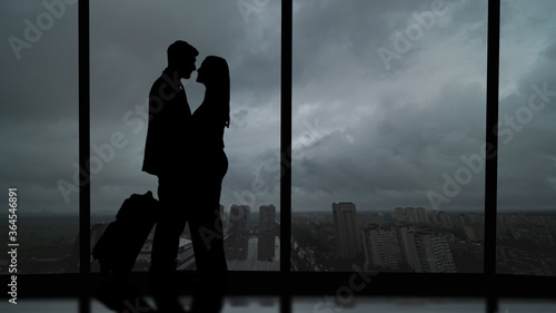 The romantic couple standing in the big hall with a beautiful sky view