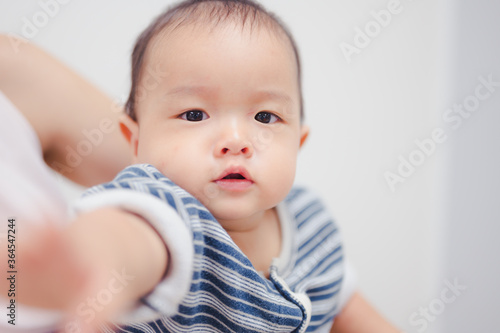 8 months baby boy portrait, asian kid face, little boy looking at camera