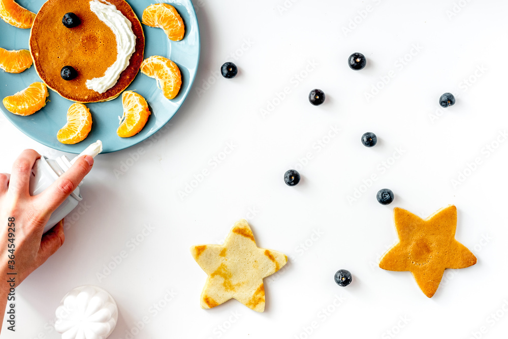 concept kid breakfast with pancake top view on white background