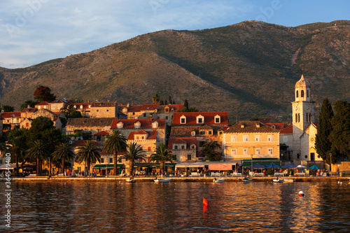 Cavtat, Croatia: the evening sun lights the bars and restaurants that line the harbour,