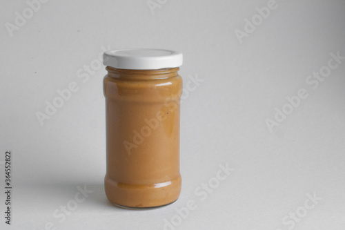 jar of peanut butter on a white background 