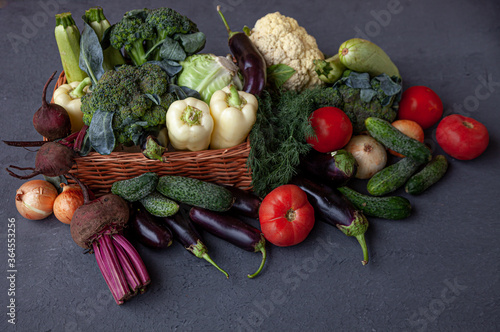 Fototapeta Naklejka Na Ścianę i Meble -  Healthy food. Fresh vegetables on the table black background. Set of food clean eating. Broccoli, cabbage, eggplant, white cabbage, cucumber, onions, beets, dill, cauliflower. Top view. Copy space.