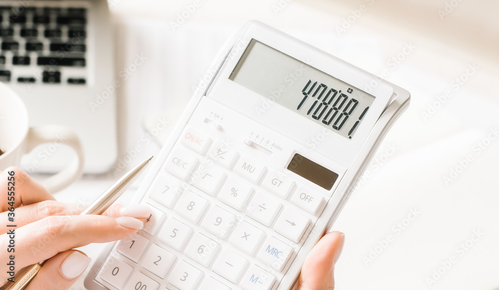 Close up businessman hand using calculator and writing make note with calculate about finance accounting.finance accounting concept Close up businessman hand using calculator and writing make note with calculate about finance accounting.finance accounting concept