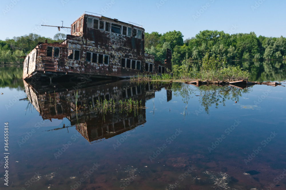 Abandoned sunken Barges Boats On River Pripyat in Chernobyl exclusion Zone. Chernobyl Nuclear Power Plant Zone of Alienation in Ukraine Abandoned sunken Barges Boats On River Pripyat in Chernobyl exclusion Zone. Chernobyl Nuclear Power Plant Zone of Alienation in Ukraine