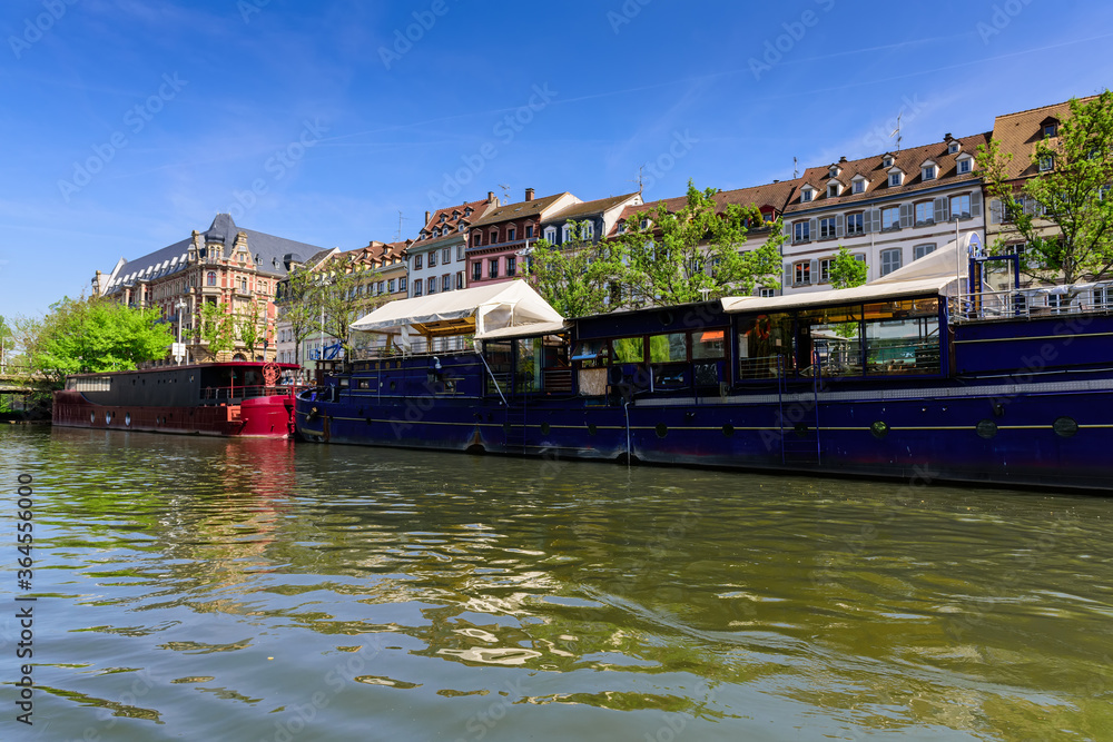 Canal view of Srasbourg architecture, the promenade and old barges converted to floating hotels and restaurants