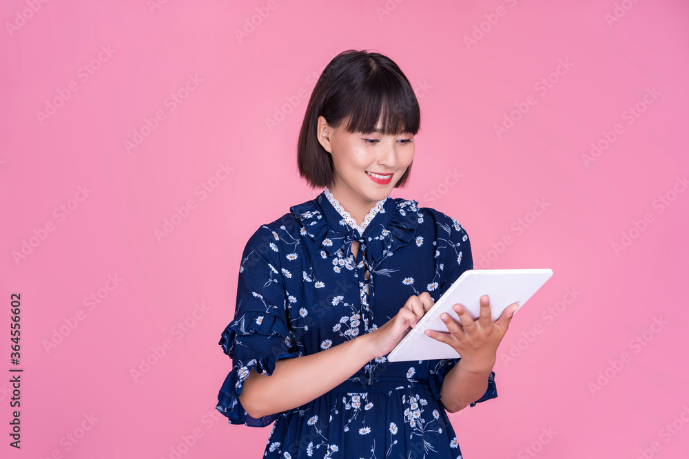 Asian attractive cute short hair woman happy smiling using smart tablet device technology confident independent mother businesswoman planning research wearing dress pink isolated background portrait Asian attractive cute short hair woman happy smiling using smart tablet device technology confident independent mother businesswoman planning research wearing dress pink isolated background portrait