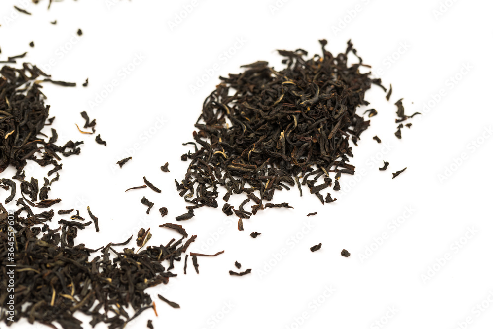 Leaves of black premium dry tea on a white background Leaves of black premium dry tea on a white background