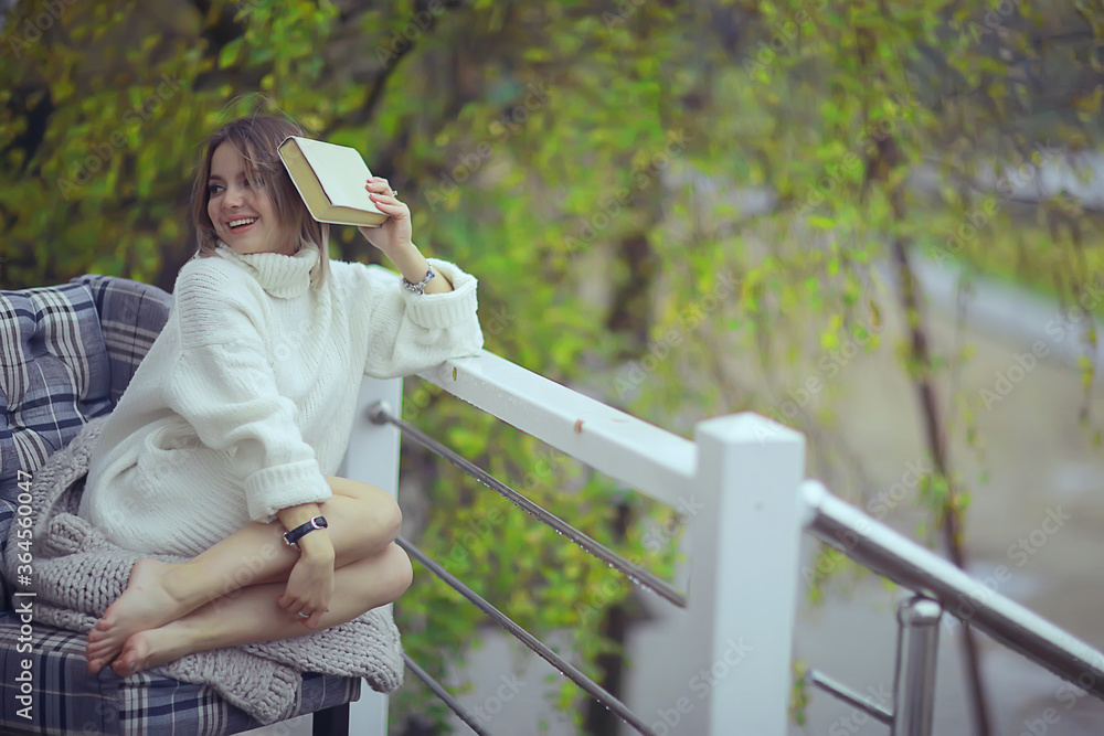 green trees book girl spring, young beautiful girl reads a book on the veranda seasonal look