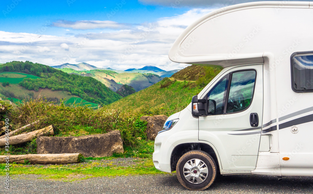Partial view of a camper with a landscape of the Atlantic Pyrenees in the background, Nouvelle-Aquitaine, France 