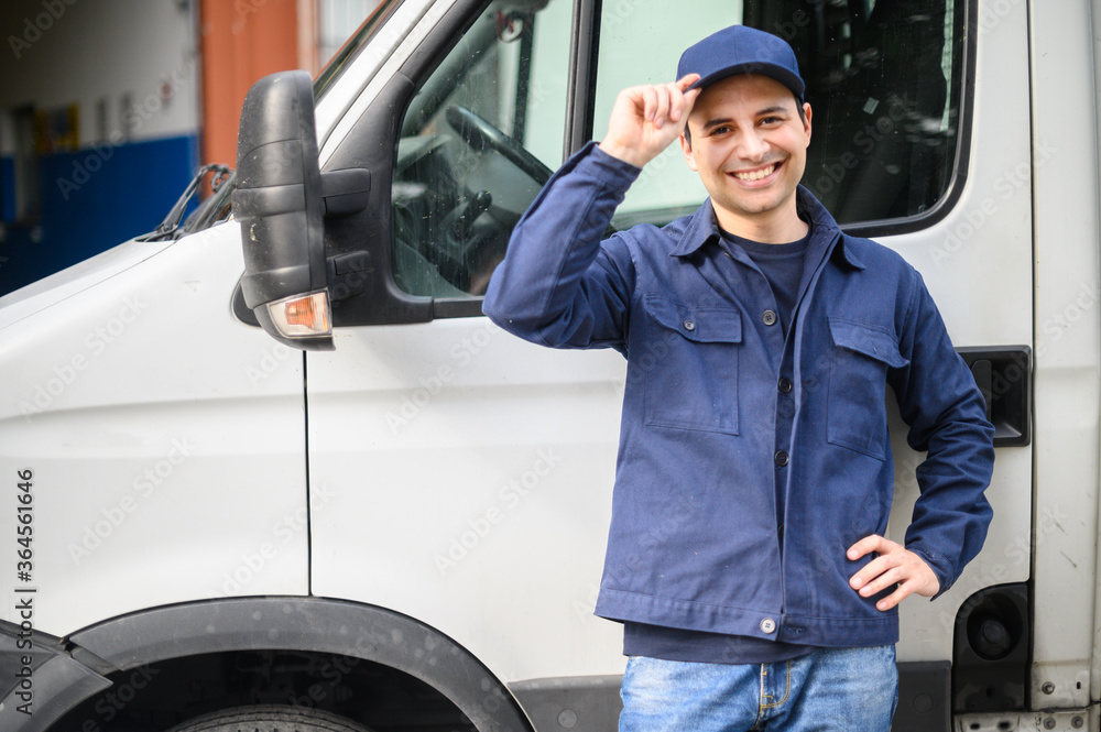 Portrait of a driver standing enar his van and smiling - obrazy, fototapety, plakaty 
