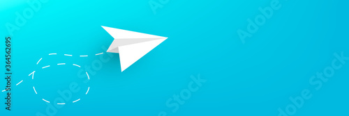 Paper plane on a blue horizontal background copy space. photo