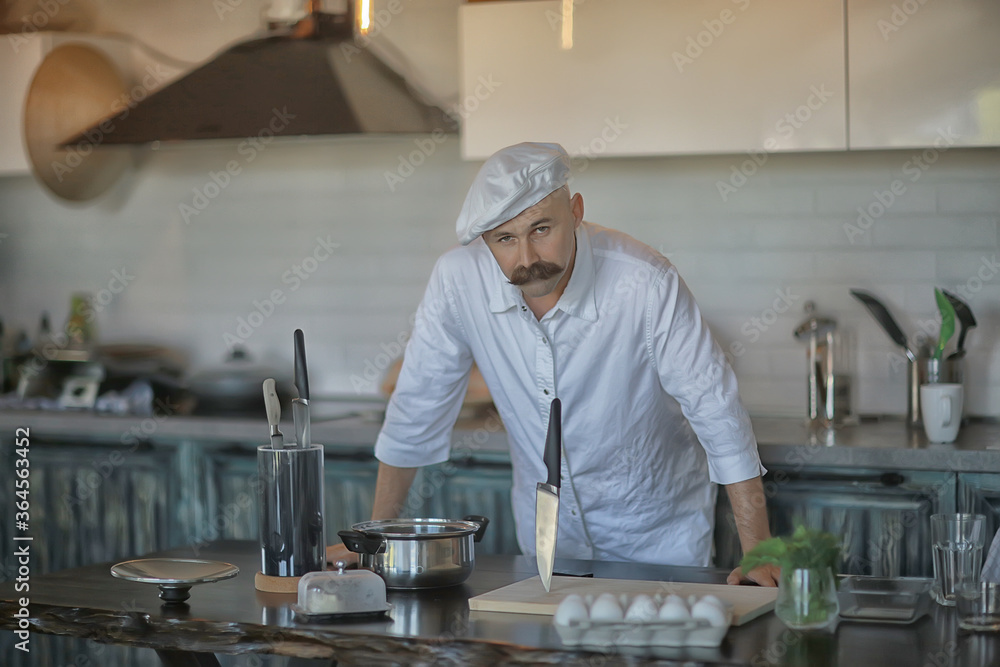 french chef in the kitchen preparing food, cooking, haute cuisine, man with mustache french chef in the kitchen preparing food, cooking, haute cuisine, man with mustache