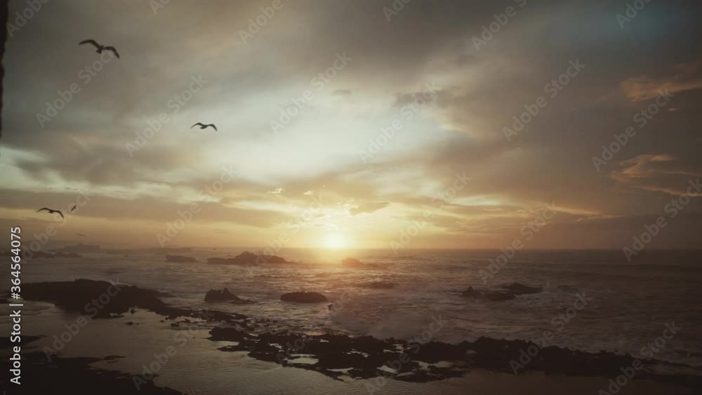 sea view with small waves splashing on rocks of Essaouira Morocco beach , seashore idyllic colours at sunset authentic Atlantic ocean sea view with small waves splashing on rocks of Essaouira Morocco beach , seashore idyllic colours at sunset authentic Atlantic ocean