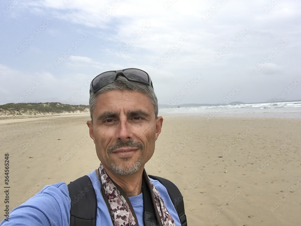 Male tourist taking a selfie on a Wilsons Prom Beach, Australia Male tourist taking a selfie on a Wilsons Prom Beach, Australia