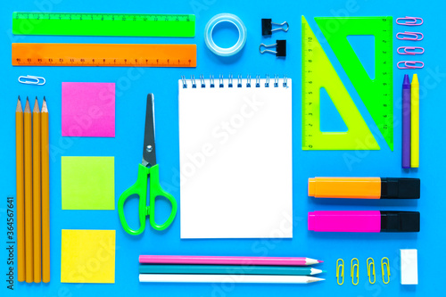 School colorful supplies border on blue, flatlay, top view, back to school, copy space, mockup, knolling stily photo