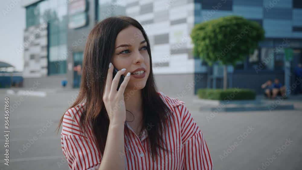 Happy young woman talking over phone. near modern office building. Businesswoman using smartphone. Smiling girl talking on phone outdoors. Happy young woman talking over phone. near modern office building. Businesswoman using smartphone. Smiling girl talking on phone outdoors.
