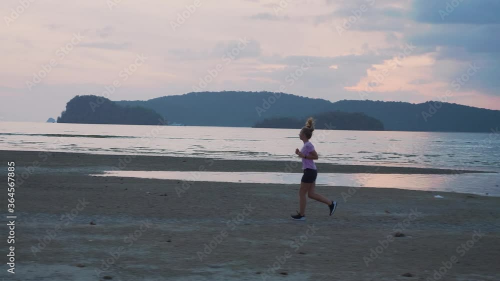 Woman Jogging by the Ocean Beach Woman Jogging by the Ocean Beach