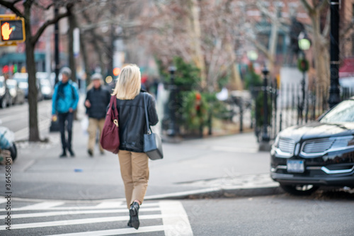 Back view of beautiful blonde business woman walking along New York City street © jovannig