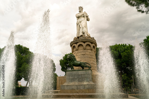 The statue of El Batallador in the Parque Grande José Antonio Labordeta with the fountain jets in the foreground in Zaragoza, province of Aragon, Spain photo