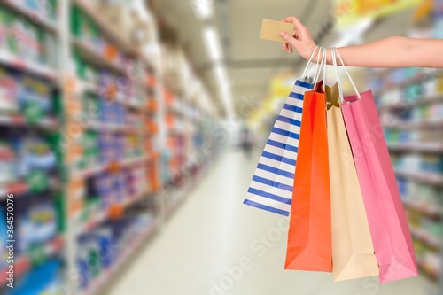 Woman hand with many shopping bags and credit card