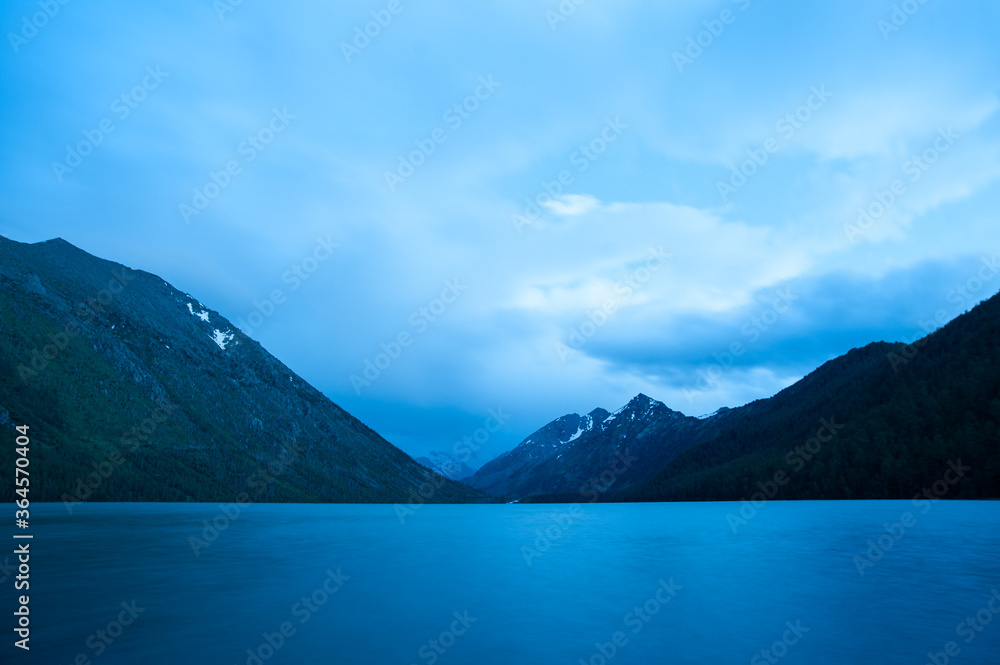 Altai Mountain at night. first Multin Lake with clouds