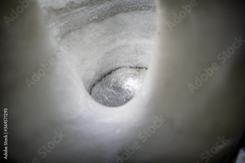 Ice wall with hole, ice cave in Iceland