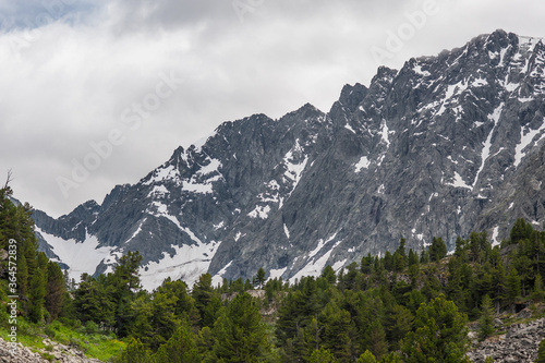 snowy cliffs with overcast skies in the Altai Mountains