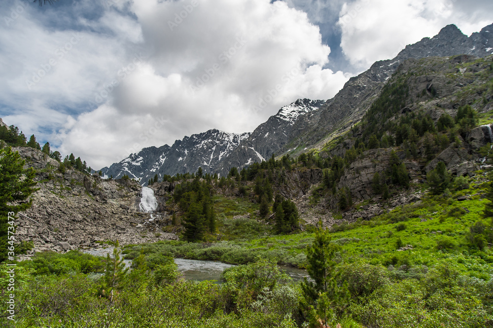 waterfall against the backdrop of mountains in the Altai Mountains 