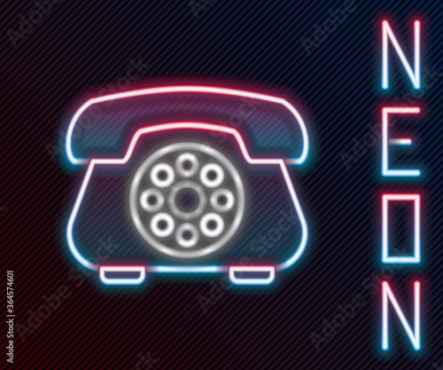 Glowing neon line Telephone icon isolated on black background. Landline phone. Colorful outline concept. Vector Illustration.