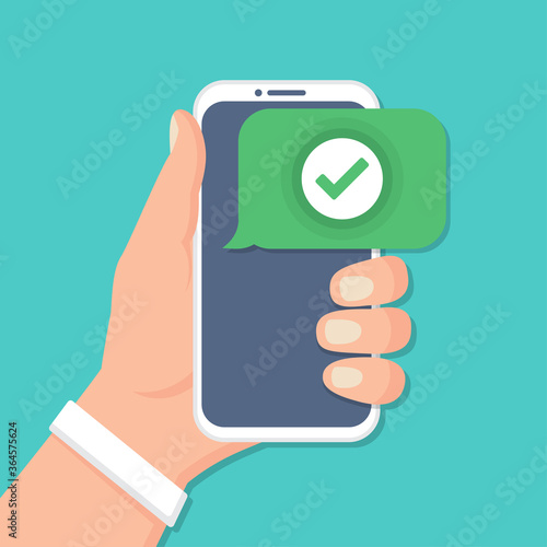 Hand holding smartphone with check icon in a flat design