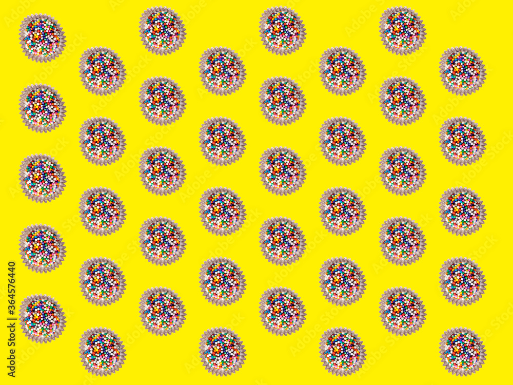 Brigadeiro, a traditional Brazilian chocolate candy. Continuous repeat pattern over colored background. Brigadeiro, a traditional Brazilian chocolate candy. Continuous repeat pattern over colored background.