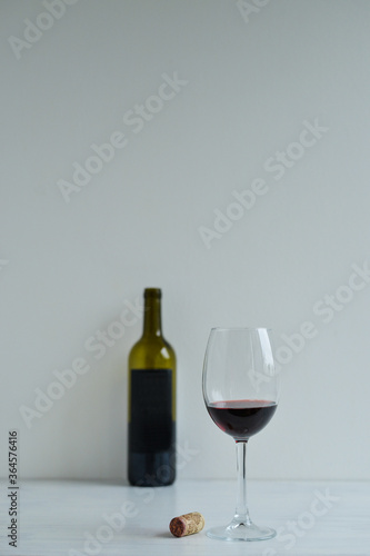 Red wine standing one the white table