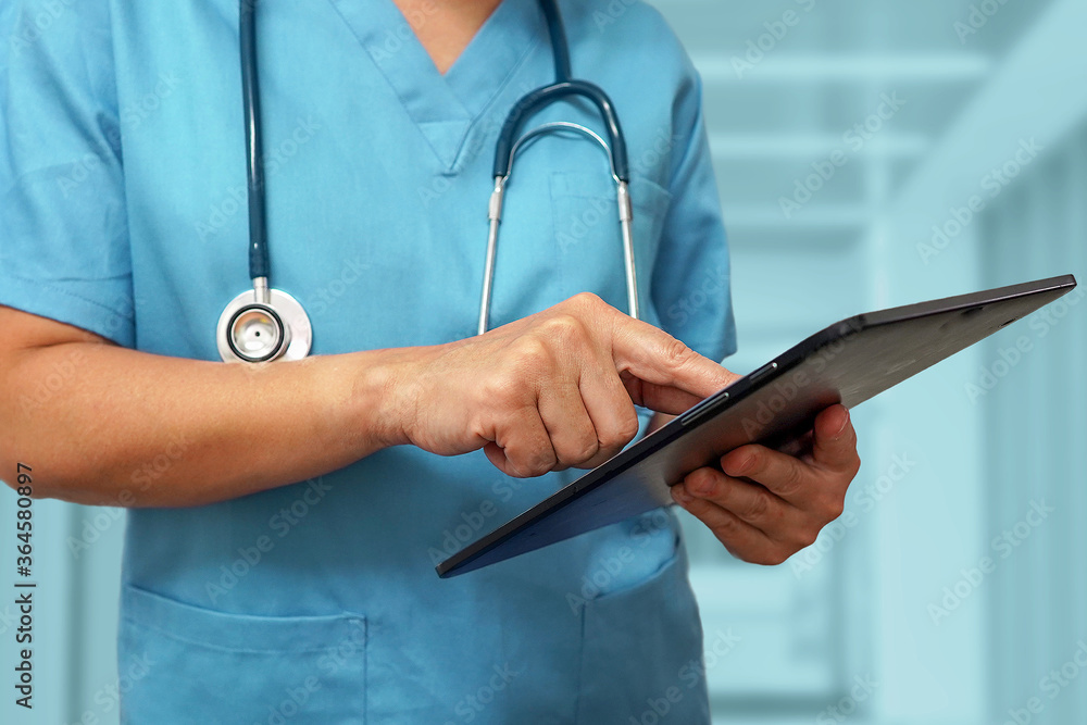 Healthcare and medicine. Surgeon or doctor using a digital tablet. Medical equipment or medical network. The doctor uses a digital tablet. Healthcare and medicine. Surgeon or doctor using a digital tablet. Medical equipment or medical network. The doctor uses a digital tablet.