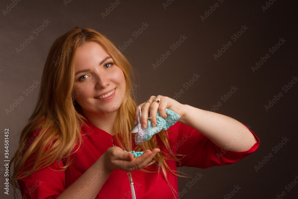 a blonde girl with an overweight plus size, in a red overallposing on a dark Studio background a blonde girl with an overweight plus size, in a red overallposing on a dark Studio background