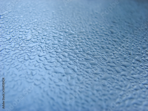 Blue metallic surface with droplets