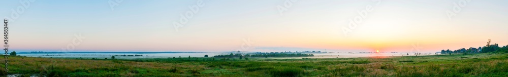 Panorama of dawn fire in the sky above the natural pasture. Golden red clouds just before sunrise. Picturesque landscape at sunrise. Beauty in nature Panorama of dawn fire in the sky above the natural pasture. Golden red clouds just before sunrise. Picturesque landscape at sunrise. Beauty in nature
