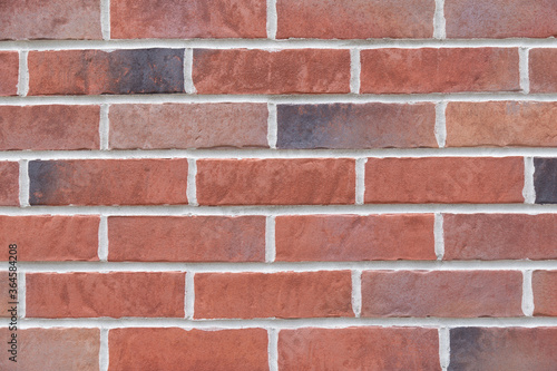 Vintage stained red brick wall close up texture background 