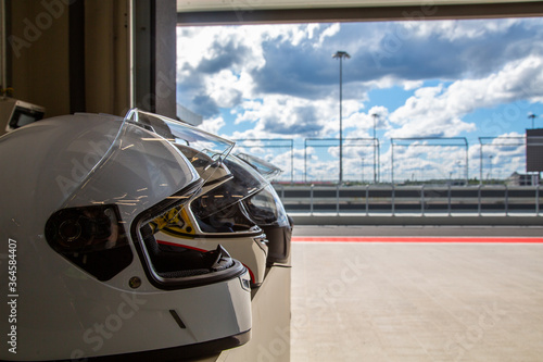 Racing helmets on the track background