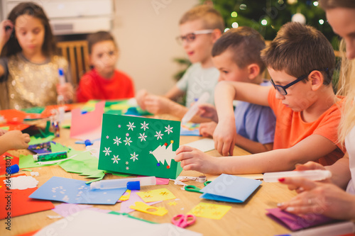 Kids engaged into creating handmade Christmas cards