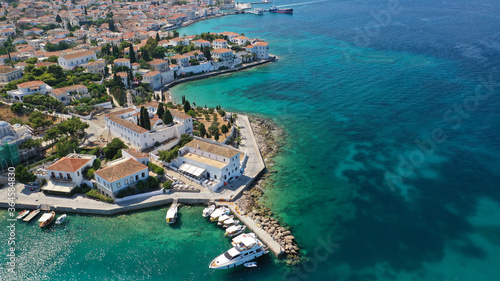 Aerial drone bird's eye view photo of picturesque neoclassic houses in historic and traditional island of Spetses with emerald clear waters, Saronic Gulf, Greece © aerial-drone