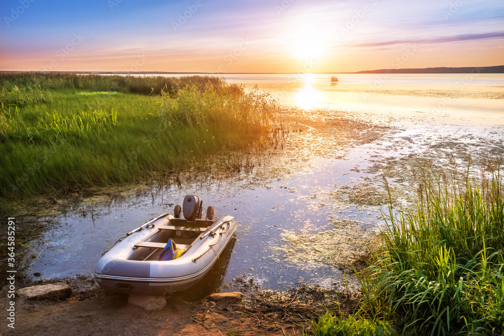 Inflatable boat on the lake in the city of Galich, Kostroma region Inflatable boat on the lake in the city of Galich, Kostroma region