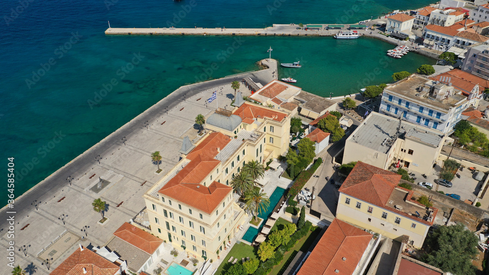 Aerial drone bird's eye view photo of picturesque neoclassic houses in historic and traditional island of Spetses with emerald clear waters, Saronic Gulf, Greece