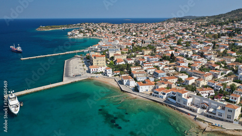 Fototapeta Naklejka Na Ścianę i Meble -  Aerial drone bird's eye view photo of picturesque neoclassic houses in historic and traditional island of Spetses with emerald clear waters, Saronic Gulf, Greece