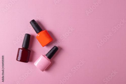 Fototapeta Naklejka Na Ścianę i Meble -  different cosmetic items and nail polish on pink background