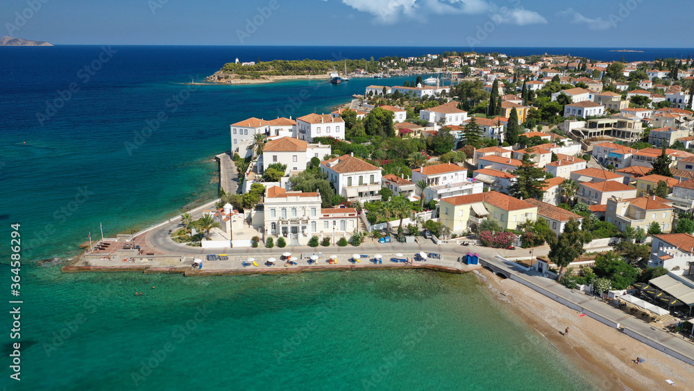 Aerial drone bird's eye view photo of picturesque neoclassic houses in historic and traditional island of Spetses with emerald clear waters, Saronic Gulf, Greece