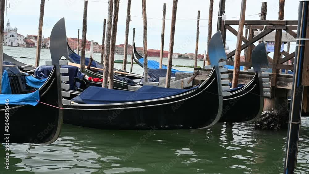 Venice, Italy - gondolas and gondoliers in the Grand Canal near the Rialto Bridge, in the San Marco Basin and between the canals of the lagoon city Venice, Italy - gondolas and gondoliers in the Grand Canal near the Rialto Bridge, in the San Marco Basin and between the canals of the lagoon city