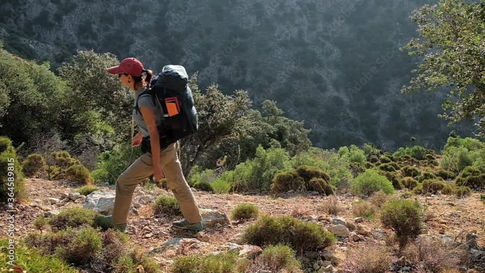 Young woman with backpack walk the Lycian way hiking trail in Turkey.