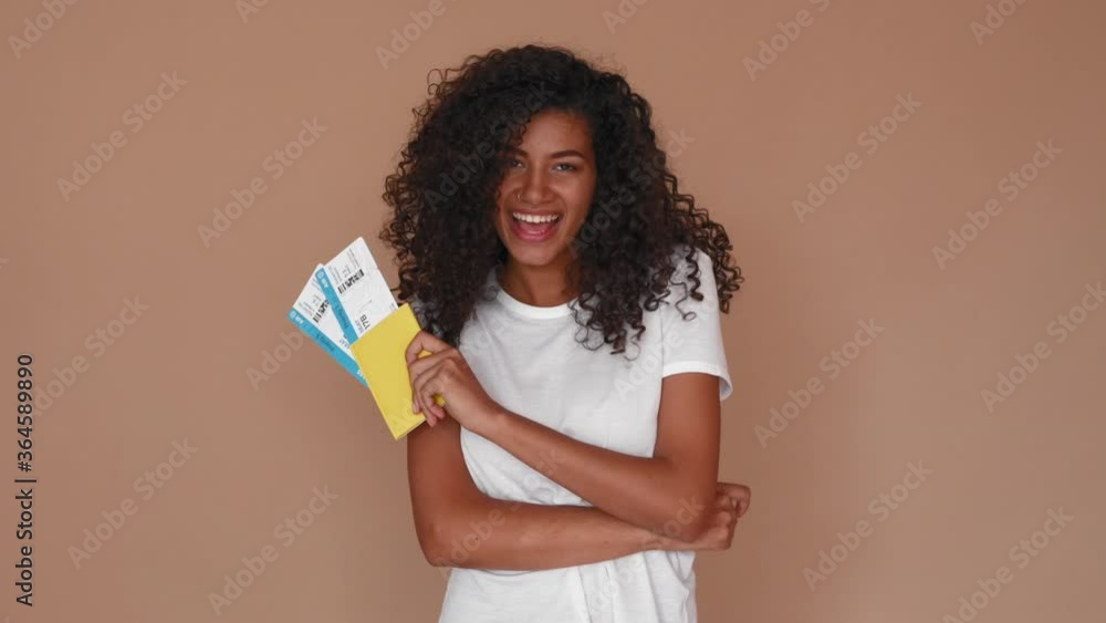 african black woman with international passport and airplane tickets smiling showing thumbs up african black woman with international passport and airplane tickets smiling showing thumbs up