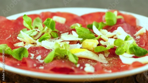 fallen olive oil on dish of dried beef with parmesan and salad