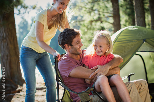 Smiling family at campsite in woods © Paul Bradbury/KOTO